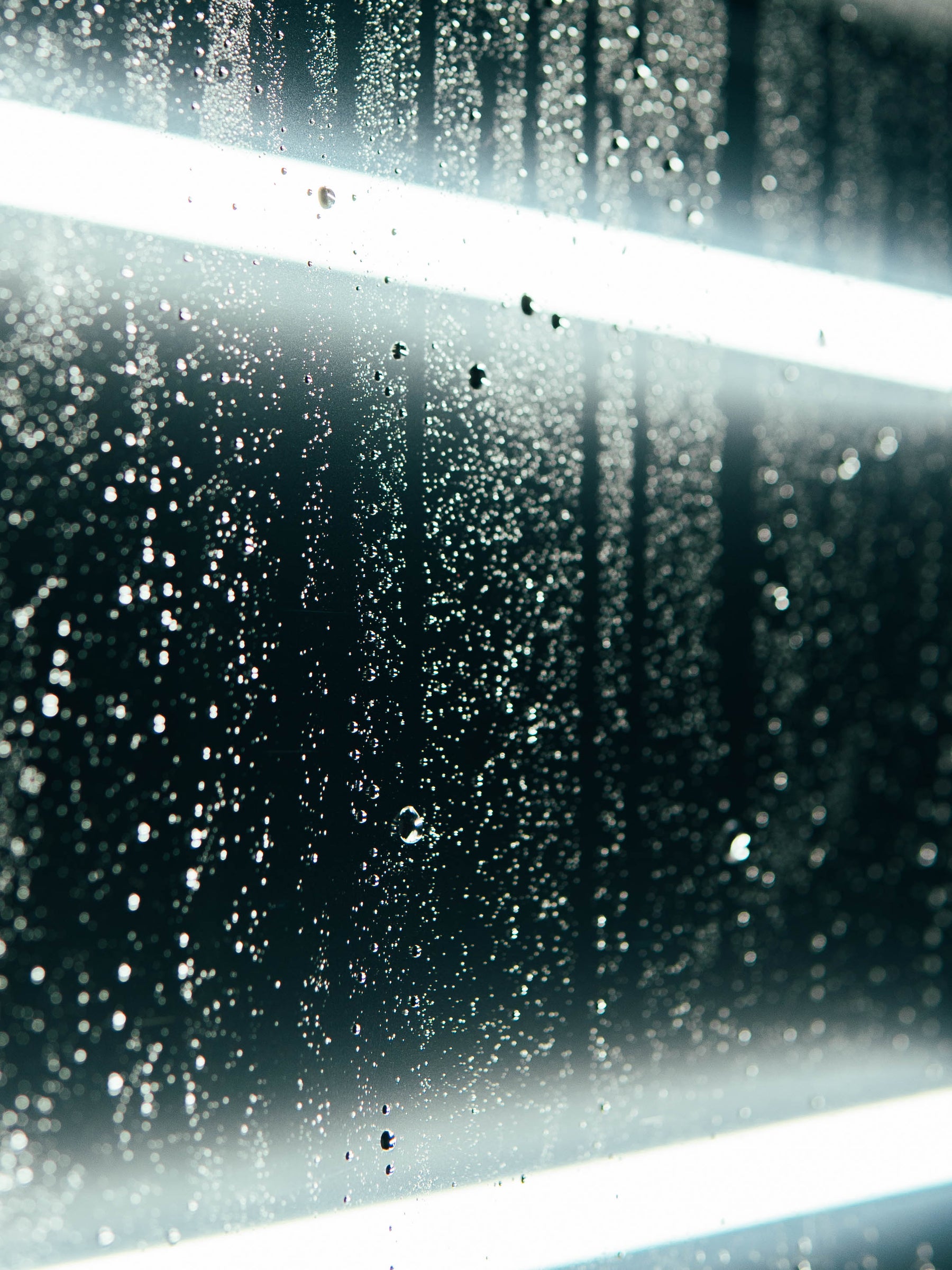 close up of ExoShield ULTRA DIY windshield protection film with water on it.