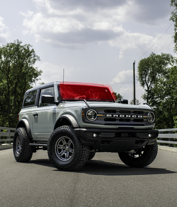 bronco with ExoShield ULTRA DIY windshield protection film installed on it. parked on a bridge