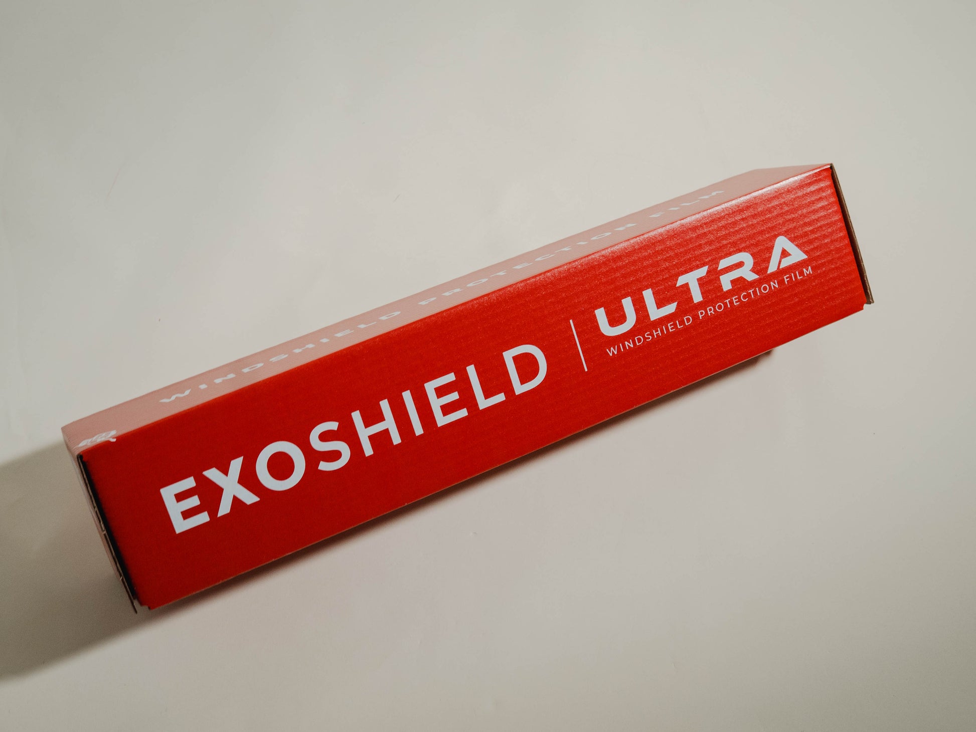 Red box of Exoshield Ultra windshield protection film on a light gray background