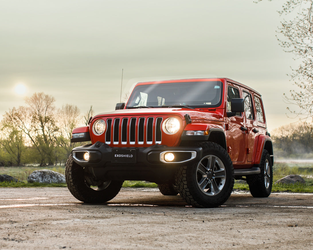 red Jeep parked in an offroad setting with ExoShield ULTRA DIY windshield protection film