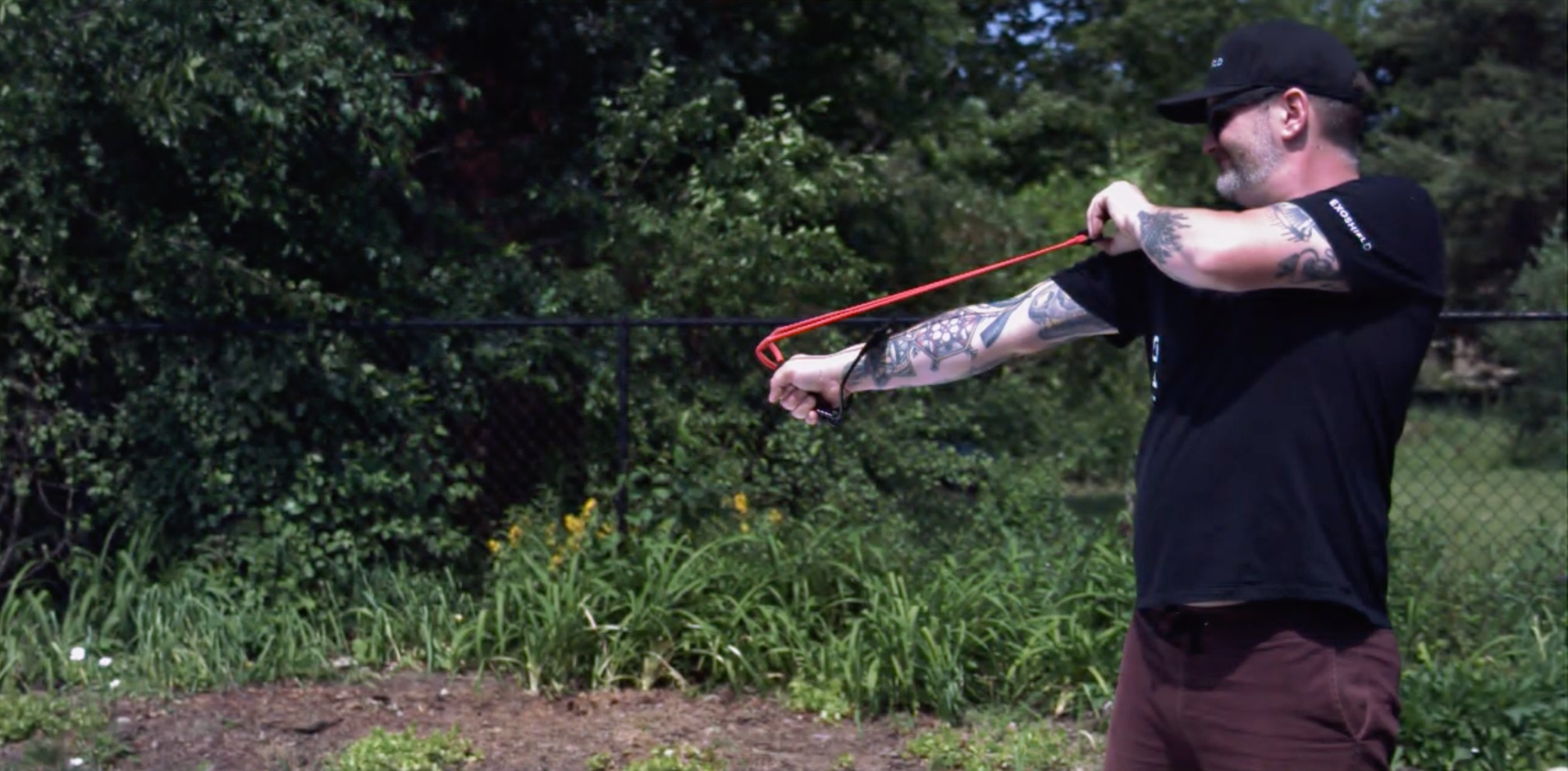 man pulling a slingshot back to show how strong ExoShield ULTRA DIY is and how it can protect upright windshields. 